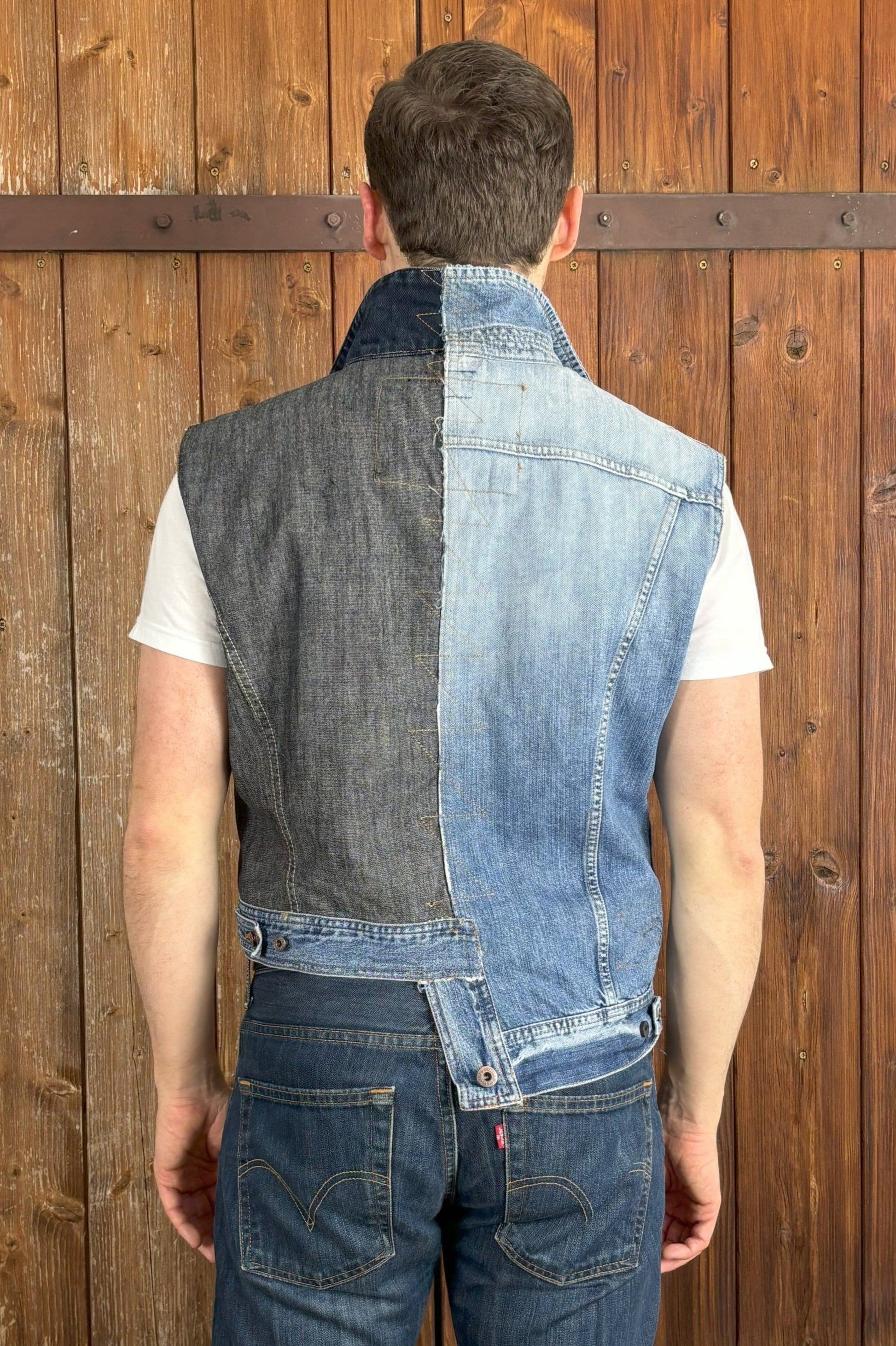 Die Rückseite der einzigartigen, asymmetrischen Jeansweste zeigt die Kombination aus einer hellblauen und einer dunkelblauen Jeansjacke mit hellblauem Abschluss.